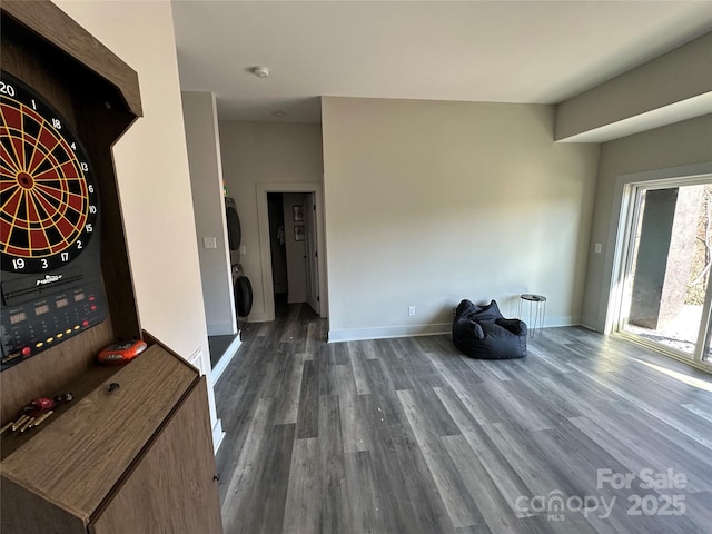 3149 Winter Hawk Ln, Lenoir, NC 28645 - unfurnished living room with estacked washer and dryer, wood finished floors, and baseboards