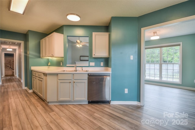 330 Kilmer Ln, Mooresville, NC 28115 - kitchen with dishwasher, a sink, light wood finished floors, baseboards, and light countertops
