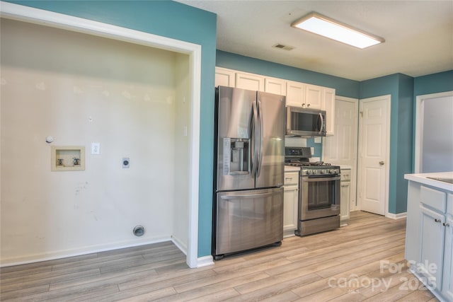 330 Kilmer Ln, Mooresville, NC 28115 - kitchen with stainless steel appliances, light wood finished floors, baseboards, and light countertops