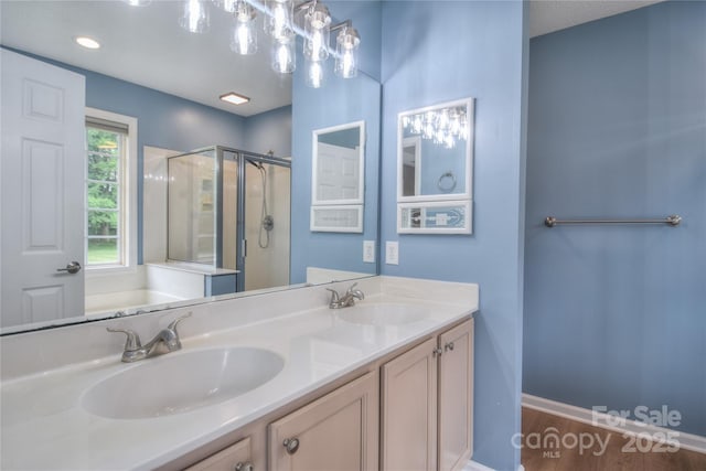 330 Kilmer Ln, Mooresville, NC 28115 - bathroom featuring a shower stall, double vanity, and wood finished floors