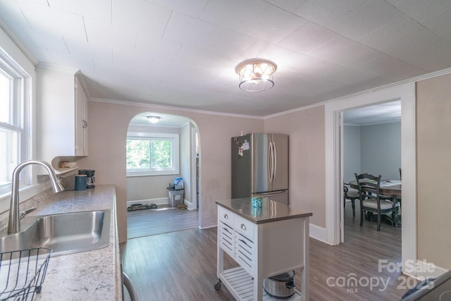28782 Canton Rd Unit A, Albemarle, NC 28001 - kitchen featuring freestanding refrigerator, a sink, arched walkways, white cabinetry, and crown molding