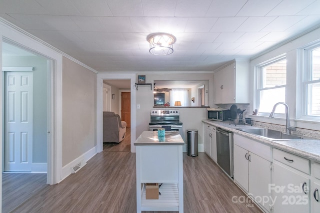 28782 Canton Rd Unit A, Albemarle, NC 28001 - kitchen featuring appliances with stainless steel finishes, a sink, white cabinets, wood finished floors, and light countertops