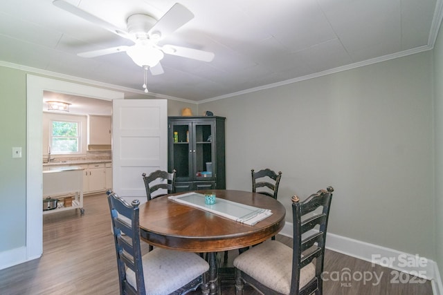 28782 Canton Rd Unit A, Albemarle, NC 28001 - dining area featuring wood finished floors, ornamental molding, ceiling fan, and baseboards
