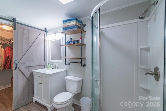 28782 Canton Rd Unit A, Albemarle, NC 28001 - bathroom featuring wood finished floors, a stall shower, vanity, baseboards, and toilet