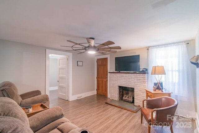 28782 Canton Rd Unit A, Albemarle, NC 28001 - living room featuring ceiling fan, wood finished floors, a fireplace, and baseboards
