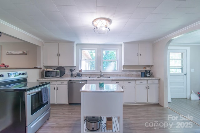 28782 Canton Rd Unit A, Albemarle, NC 28001 - kitchen with stainless steel appliances, a sink, arched walkways, plenty of natural light, and crown molding