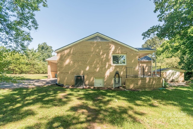 28782 Canton Rd Unit A, Albemarle, NC 28001 - rear view of house featuring brick siding, central AC unit, a yard, a shed, and an outbuilding