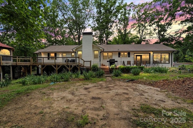 603 Sunnybrook Dr, Monroe, NC 28110 - back of property at dusk featuring a deck and a chimney