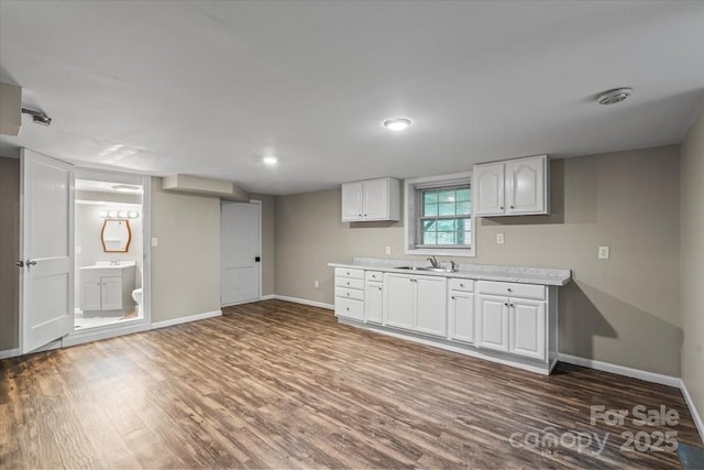 603 Sunnybrook Dr, Monroe, NC 28110 - kitchen with wood finished floors, baseboards, light countertops, and a sink