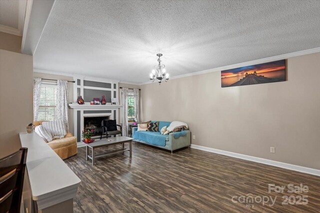 603 Sunnybrook Dr, Monroe, NC 28110 - living room with plenty of natural light, dark wood-style flooring, crown molding, a chandelier, and baseboards