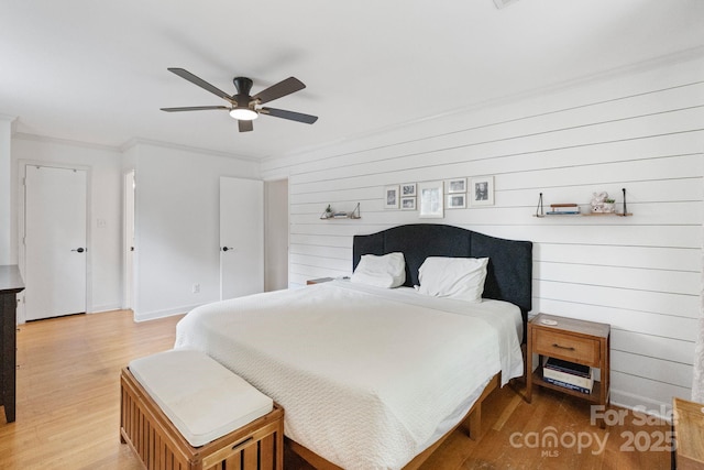 1014 Vandalia Dr, Charlotte, NC 28212 - bedroom with light wood-style flooring, ornamental molding, baseboards, ceiling fan, and wooden walls
