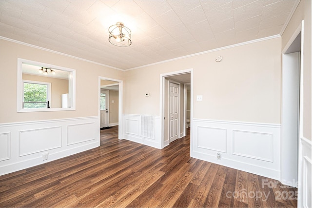 210 W 15th St, Newton, NC 28658 - empty room with crown molding, dark wood-style flooring, a wainscoted wall, and a chandelier