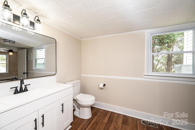 210 W 15th St, Newton, NC 28658 - bathroom with wood finished floors, toilet, vanity, ornamental molding, and baseboards