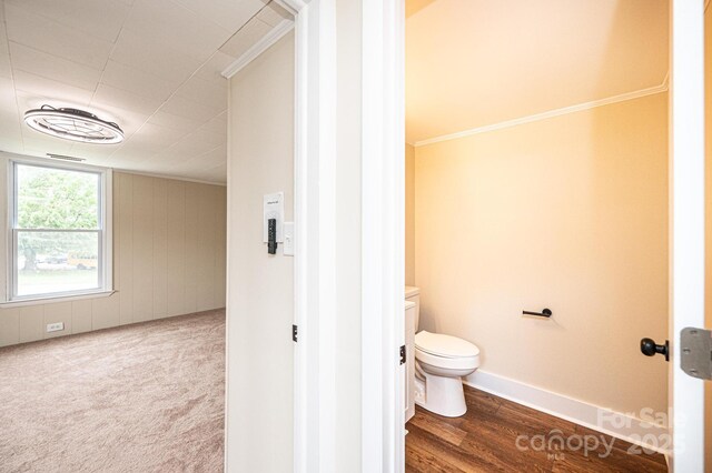 210 W 15th St, Newton, NC 28658 - bathroom featuring ornamental molding, toilet, and wood finished floors