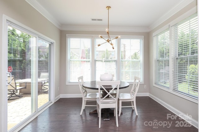 dining area with plenty of natural light, a chandelier, baseboards, dark wood-type flooring, and ornamental molding