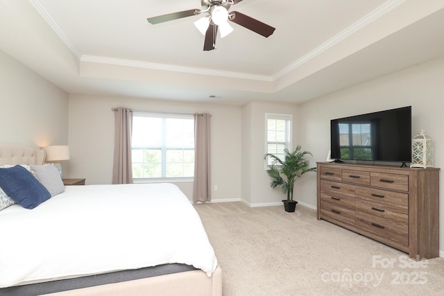 bedroom with light carpet, a tray ceiling, crown molding, baseboards, and a ceiling fan
