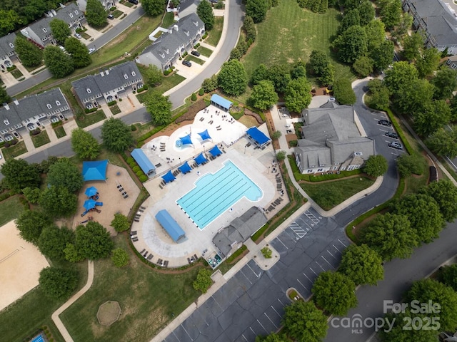 aerial perspective of suburban area featuring a pool area
