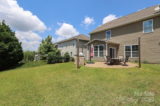 rear view of property featuring a lawn, a patio, and a fire pit