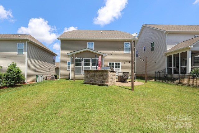 back of house featuring a sunroom and a yard