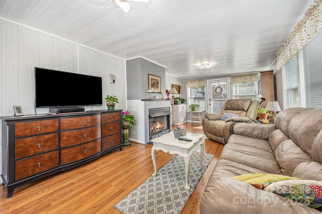 125 Maple St, New London, NC 28127 - living area with light wood-type flooring and a warm lit fireplace