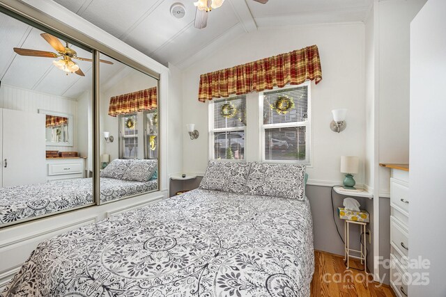 125 Maple St, New London, NC 28127 - bedroom with wood finished floors, multiple windows, access to exterior, and a ceiling fan