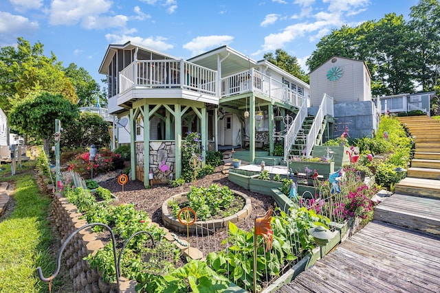 125 Maple St, New London, NC 28127 - rear view of property featuring stairs, a garden, and a wooden deck