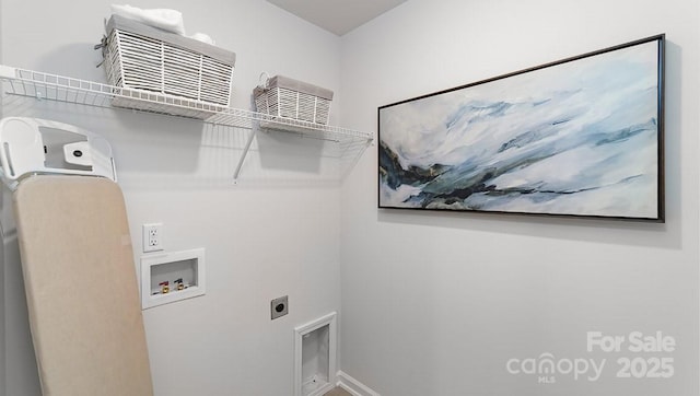 washroom with electric dryer hookup, hookup for a washing machine, and baseboards