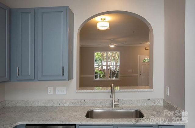 4938 Sunset Ridge Ct, Charlotte, NC 28269 - kitchen with a sink, ceiling fan, arched walkways, and blue cabinetry