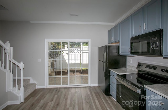 4938 Sunset Ridge Ct, Charlotte, NC 28269 - kitchen featuring black microwave, stainless steel electric range, baseboards, light wood-type flooring, and crown molding