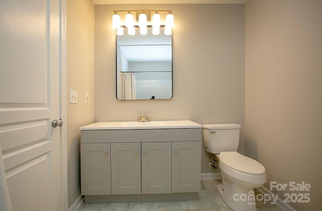 4938 Sunset Ridge Ct, Charlotte, NC 28269 - bathroom featuring baseboards, toilet, vanity, and tile patterned flooring
