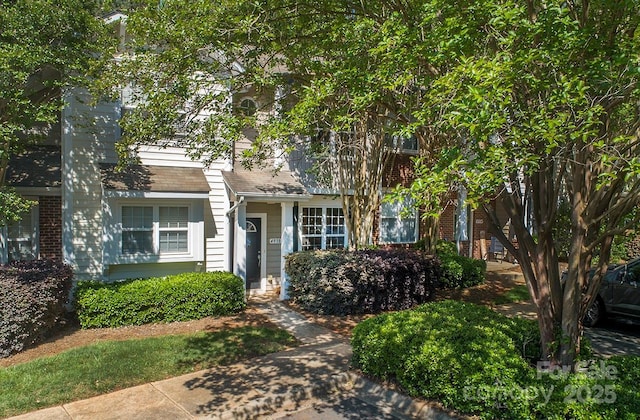 4938 Sunset Ridge Ct, Charlotte, NC 28269 - obstructed view of property featuring a chimney and brick siding
