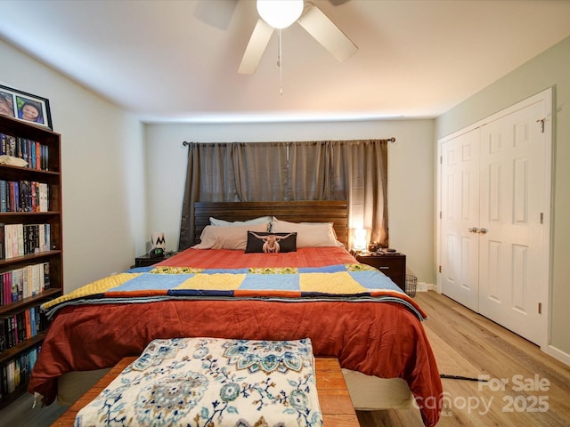 bedroom with wood finished floors, ceiling fan, and a closet