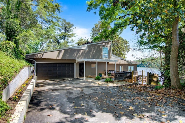 6664 Lake Shore Dr, Hickory, NC 28601 - view of front of home with driveway, an attached garage, covered porch, and stucco siding