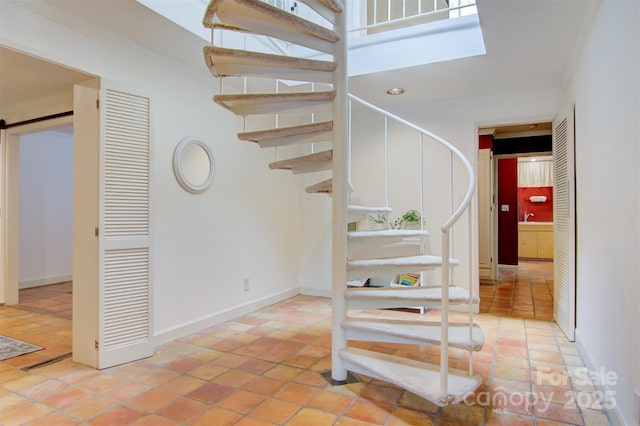 6664 Lake Shore Dr, Hickory, NC 28601 - stairway featuring a barn door, a towering ceiling, tile patterned floors, baseboards, and crown molding
