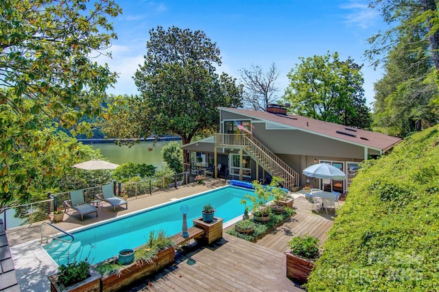 6664 Lake Shore Dr, Hickory, NC 28601 - view of swimming pool featuring a deck with water view, stairway, and outdoor dining area