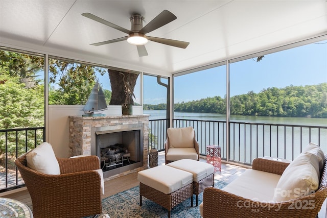 6664 Lake Shore Dr, Hickory, NC 28601 - sunroom featuring a stone fireplace, ceiling fan, wood finished floors, and a water view