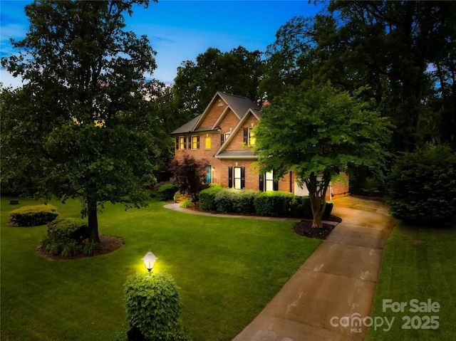 4339 Shannamara Dr, Matthews, NC 28104 - view of front facade featuring a front yard, brick siding, and driveway