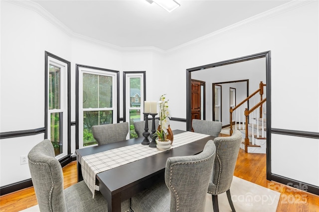 4339 Shannamara Dr, Matthews, NC 28104 - dining space with ornamental molding, wood finished floors, and stairs