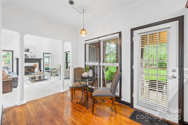 4339 Shannamara Dr, Matthews, NC 28104 - sitting room with decorative columns, ornamental molding, wood finished floors, and a fireplace