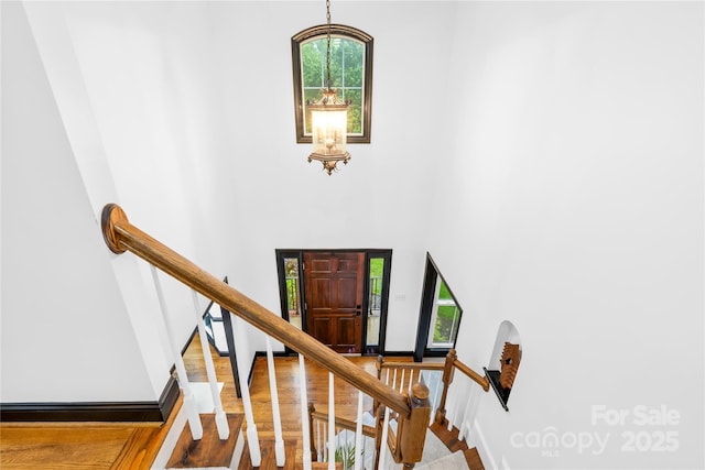 4339 Shannamara Dr, Matthews, NC 28104 - foyer entrance with a high ceiling, stairway, wood finished floors, and a chandelier