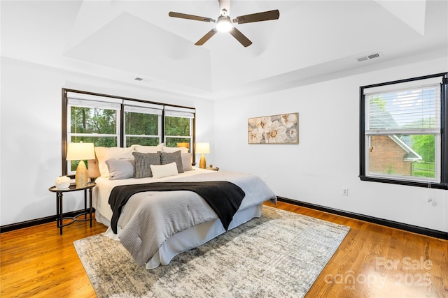 4339 Shannamara Dr, Matthews, NC 28104 - bedroom with a tray ceiling, wood finished floors, and a ceiling fan