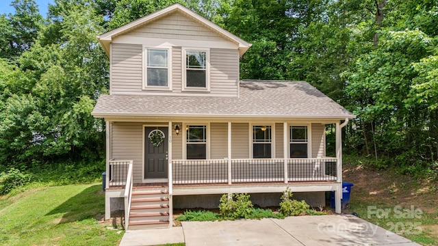 10 Coral Berry Dr, Candler, NC 28715 - view of front of house with covered porch, roof with shingles, and a front lawn