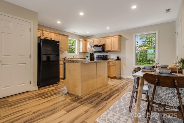 10 Coral Berry Dr, Candler, NC 28715 - kitchen with black appliances, light wood-type flooring, recessed lighting, a center island, and light brown cabinets