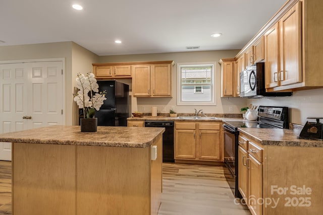 10 Coral Berry Dr, Candler, NC 28715 - kitchen with black appliances, light wood-style floors, a sink, a kitchen island, and recessed lighting