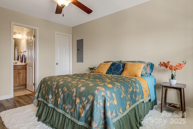 10 Coral Berry Dr, Candler, NC 28715 - bedroom with electric panel, baseboards, wood finished floors, a ceiling fan, and ensuite bath