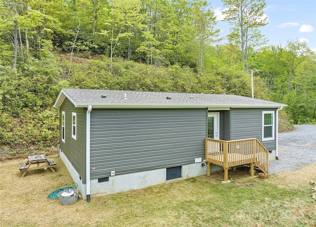 328 Mountain Lion Trl, Maggie Valley, NC 28751 - back of house featuring a wooded view, crawl space, a yard, and roof with shingles