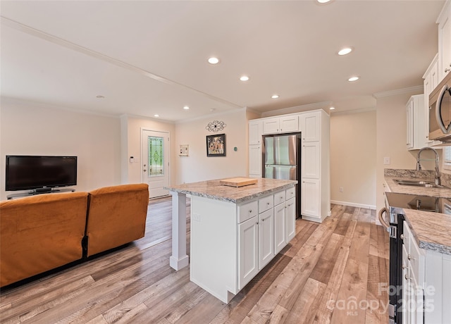 328 Mountain Lion Trl, Maggie Valley, NC 28751 - kitchen featuring a sink, appliances with stainless steel finishes, ornamental molding, a center island, and recessed lighting