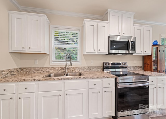 328 Mountain Lion Trl, Maggie Valley, NC 28751 - kitchen with stainless steel appliances, a sink, white cabinetry, and ornamental molding