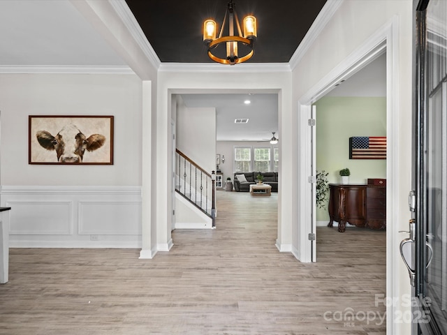 5013 Hamilton Mill Dr, Waxhaw, NC 28173 - foyer entrance with light wood-type flooring, stairs, crown molding, a chandelier, and ceiling fan