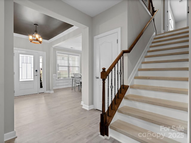 5013 Hamilton Mill Dr, Waxhaw, NC 28173 - entryway featuring a chandelier, stairway, wood finished floors, and crown molding